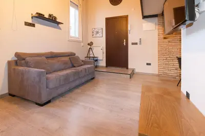 a living room with a brown couch in a room at Cozy Equipped Duplex in Poblenou Ideal for 4 Guests and Close to Public Transport in Barcelona
