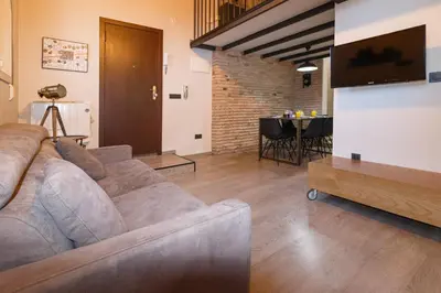 a living room with a couch and a table at Cozy Equipped Duplex in Poblenou Ideal for 4 Guests and Close to Public Transport in Barcelona