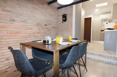 a dining room with a wooden table and chairs at Cozy Equipped Duplex in Poblenou Ideal for 4 Guests and Close to Public Transport in Barcelona