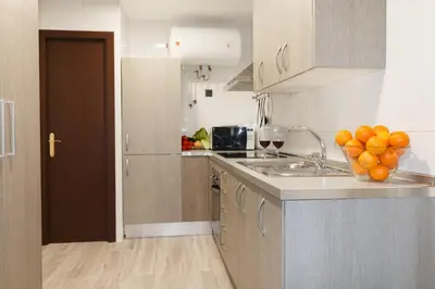 a kitchen with a bowl of oranges on the counter at Cozy Equipped Duplex in Poblenou Ideal for 4 Guests and Close to Public Transport in Barcelona