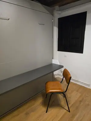 a table and a chair in a room at Industrial loft in Eixample near Sagrada familia in Barcelona