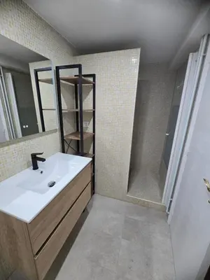 a bathroom with a sink and a shower at Industrial loft in Eixample near Sagrada familia in Barcelona