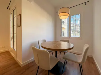 a dining room with a table and chairs and a window at Stay U-nique Apartments Balmes III in Barcelona