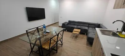 a living room with a glass table and a couch at Exquisite Flat in Martorell (Barcelona) in Martorell