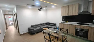 a kitchen and a living room with a couch and a table at Exquisite Flat in Martorell (Barcelona) in Martorell