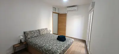 a bedroom with a bed with a blue backpack on it at Exquisite Flat in Martorell (Barcelona) in Martorell
