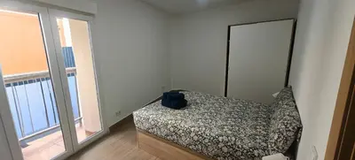 a bedroom with a bed with a backpack on it at Exquisite Flat in Martorell (Barcelona) in Martorell