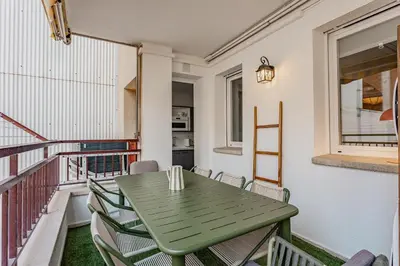 a green table and chairs on a balcony at Comfortable and spacious flat in Barcelona in Barcelona