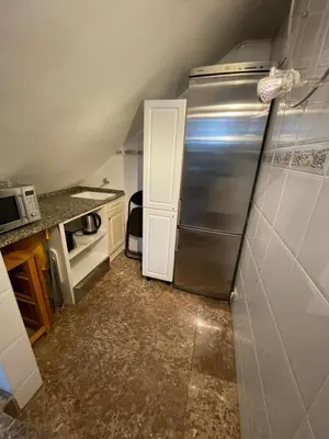 a kitchen with a stainless steel refrigerator at Casa la Luna in Badalona