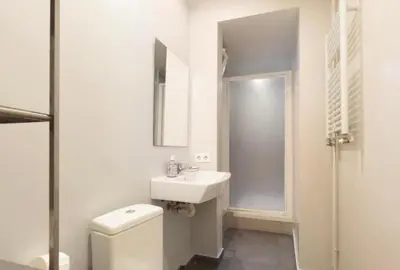 a white bathroom with a toilet and a sink at Diagonal Avenue Apartment in Barcelona
