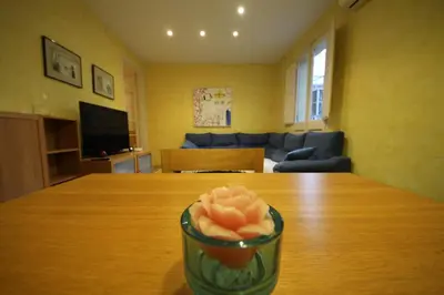 a flower in a glass bowl on a table at Plaza España Central Apartment in Barcelona