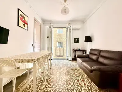 a living room with a couch and a table at Bright 3 Bedroom Apartment Central Barcelona in Barcelona
