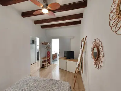 a living room with white walls and a ceiling fan at Elegant apartment Sagrada Familia in Barcelona