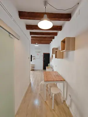 a dining room with a table and chairs in a room at Elegant apartment Sagrada Familia in Barcelona