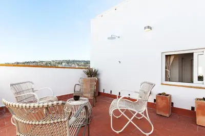 a balcony with rocking chairs and a fireplace at St. Antoni sky lounge in Barcelona