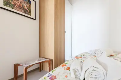 a bedroom with a bed with towels and a window at St. Antoni sky lounge in Barcelona