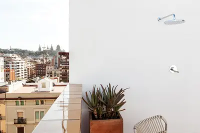 a balcony with a view of a city at St. Antoni sky lounge in Barcelona
