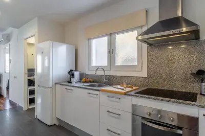 a kitchen with a white refrigerator and a sink at 4329 - AB Eixample Centric in Barcelona