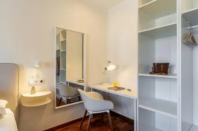 a bedroom with a desk with a chair and a mirror at 4329 - AB Eixample Centric in Barcelona