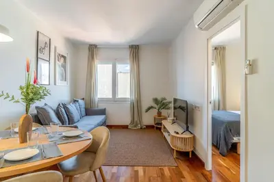 a living room with a blue couch and a table at 4329 - AB Eixample Centric in Barcelona