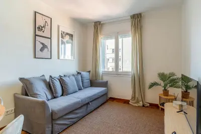 a living room with a blue couch and a window at 4329 - AB Eixample Centric in Barcelona