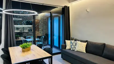 a living room with a couch and a table at Bajos con encanto by Prestigi in Terrassa