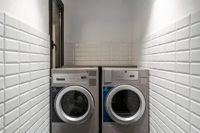 a laundry room with two washing machines in it at Enjoybcn Colon Apartments in Barcelona