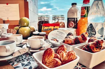 a table topped with dishes of food and drinks at Enjoybcn Colon Apartments in Barcelona