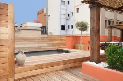 a swimming pool on the roof of a building at Enjoybcn Colon Apartments in Barcelona