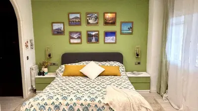 a bedroom with a bed and some pictures on the wall at Loue Villa à Castelldefels BARCELONE avec piscine, 8 couchages, 7 minutes de la plage in Castelldefels