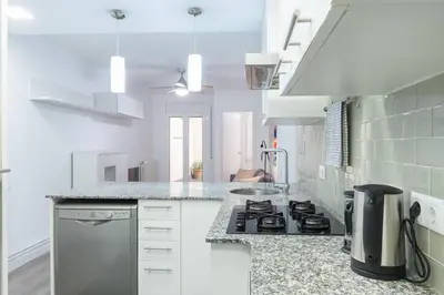 a kitchen with white counters and a stove top oven at Homenfun Barcelona Los Bunkers in Barcelona