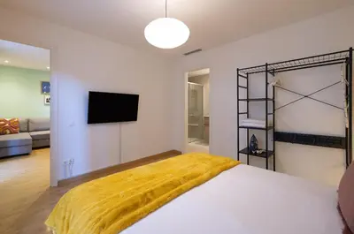 a bedroom with a bed with a yellow blanket on it at Stay U-nique Apartment Castanyer II in Barcelona