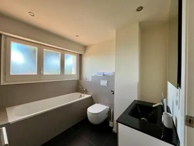 a bathroom with a tub and a toilet and a sink at Casanova, villa with Barcelona's skyline in Cabrils