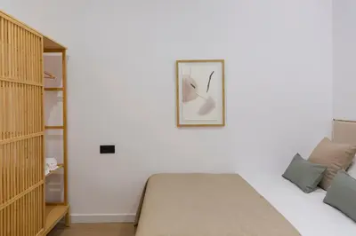 a bedroom with a bed and a picture on the wall at Barcelona - Gracia P-A in Barcelona