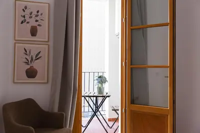a room with a chair and a glass door at Barcelona - Gracia P-B in Barcelona