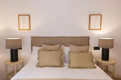 a bedroom with a white bed with two lamps at Barcelona - Gracia 1-A in Barcelona