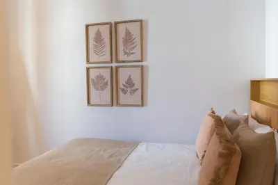 a bedroom with three pictures on the wall at Barcelona - Gracia 2-B in Barcelona