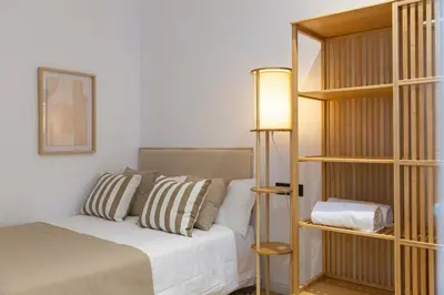 a bedroom with a bed and a book shelf at Barcelona - Gracia 4-A in Barcelona