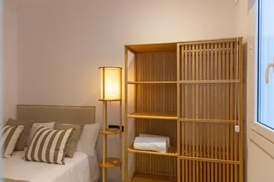 a bedroom with a book shelf next to a bed at Barcelona - Gracia 4-A in Barcelona