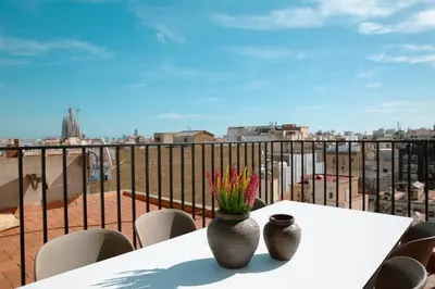 a table with a vase with flowers on a balcony at Barcelona - Gracia 5-B in Barcelona
