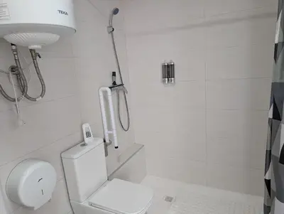 a tall building with a window and a garage at Entire apartment, accessible ground floor in Hospitalet de Llobregat