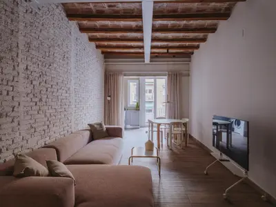 a kitchen with a sink and a table with chairs at Casa Flor Boutique Mid-term Monthly Rentals in Barcelona