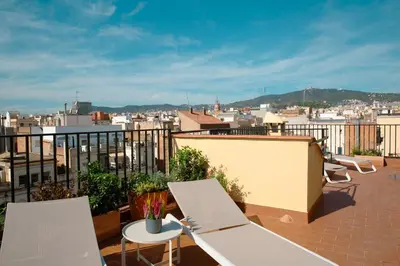 a balcony with chairs and a view of a city at Barcelona - Gracia 3-A in Barcelona