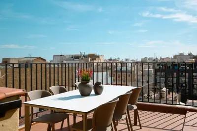 a white table and chairs on a balcony with a view at Barcelona - Gracia 3-A in Barcelona