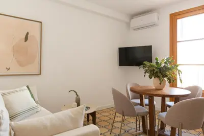 a living room with a table and a tv at Barcelona - Gracia 3-A in Barcelona