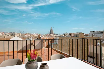 a balcony with a table and chairs and a view of a city at Barcelona - Gracia 3-B in Barcelona