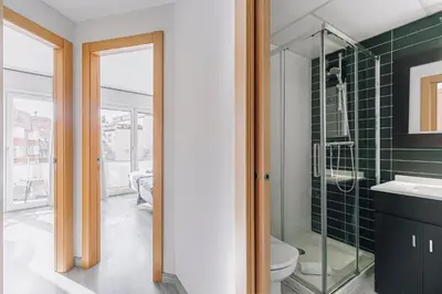 a bathroom with a toilet and a glass shower at Weflating Barcelona Sants in Barcelona