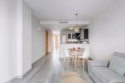 a living room and kitchen with a couch and a table at Weflating Barcelona Sants in Barcelona