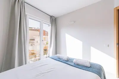 a bedroom with a bed with two towels on it at Weflating Barcelona Sants in Barcelona