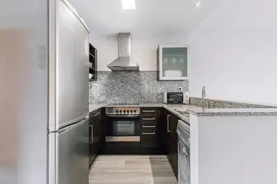 a kitchen with a stainless steel refrigerator at Weflating Barcelona Sants in Barcelona